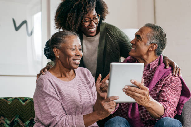istock Grandparents and their daughter with tablet 1054911372