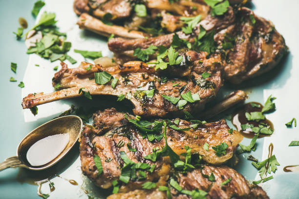 istock Grilled lamb ribs with green parsley and sauce, meat dinner 1054912978