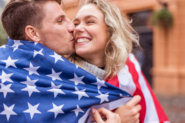 istock Happy young couple wrapped in American flag 1054913504
