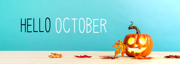 Hello October message with pumpkin on a table Hello October messag with pumpkin with leaves on a blue background hello stock pictures, royalty-free photos & images