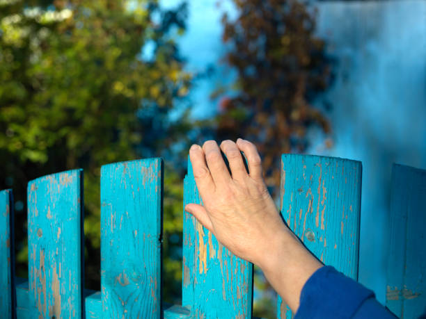 istock hand closing fence door 1054915190
