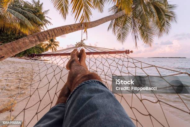 Man Lying Down On A Hammock In A Paradisiac Beach At Maldives Stock Photo - Download Image Now