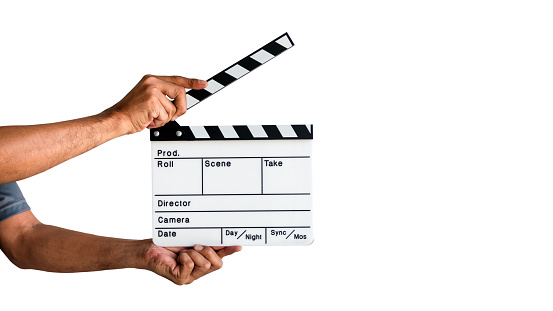 Hand holding a film clapboard slate or movie slate isolated on white background, with clipping path.