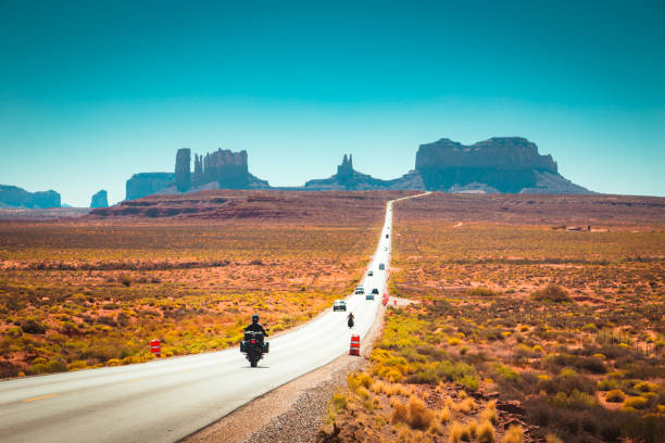 istock Biker on Monument Valley road at sunset, USA 1054916434