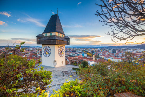 graz clock tower at sunset, graz, styria, austria - graz austria clock tower styria imagens e fotografias de stock