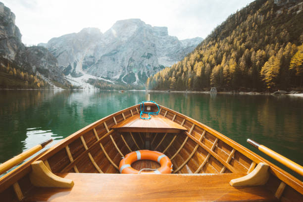 istock Traditional rowing boat on a lake in the Alps in fall 1054918394