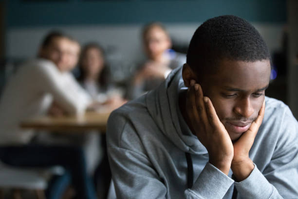 Black guy sit alone in cafe suffering from racial discrimination