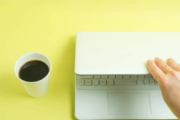 istock The coffee which was ready in a paper cup and the hand which close a PC 1054922558