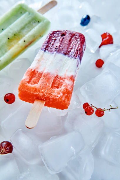 istock Berry apetitic organic ice cream lolly is represented on an ice cubes with different berries and with a copy of the space 1054923014