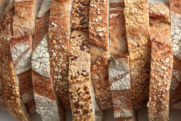 Macro photo of different pieces of fresh bread with flax seeds and sesame seeds. Healthy food. Flat lay stock photo