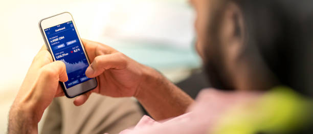 Checking his financial investment gains on a mobile app