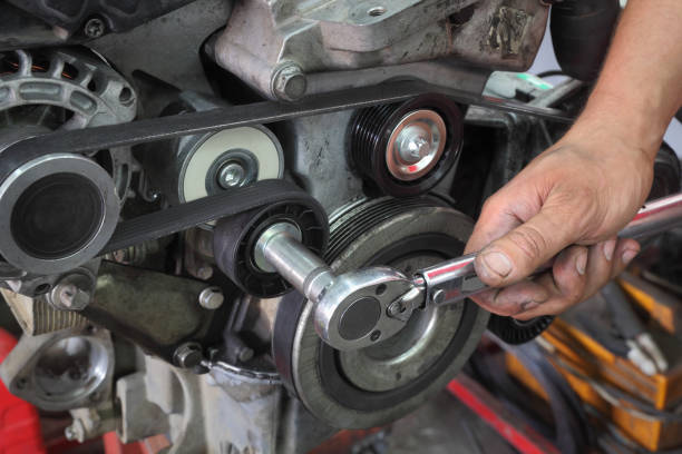 modern car servicing pulley tightening - diesel engine imagens e fotografias de stock
