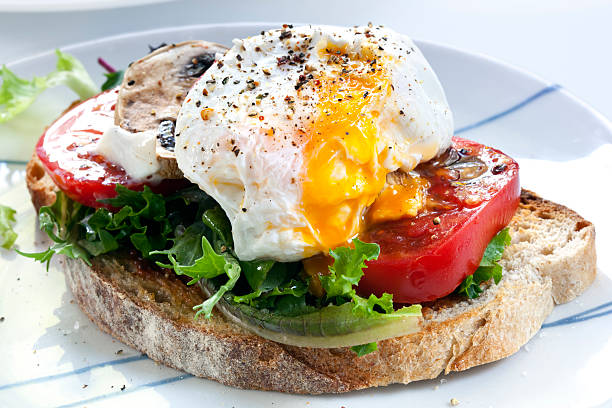 istock Perfectly done poached egg on toast with tomato and lettuce 105492694