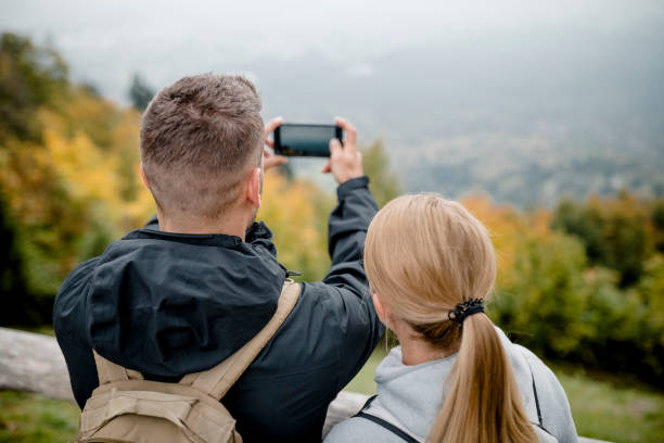istock Young couple at viewpoint in mountains 1054927126
