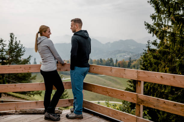 istock Young couple at viewpoint in mountains 1054927136