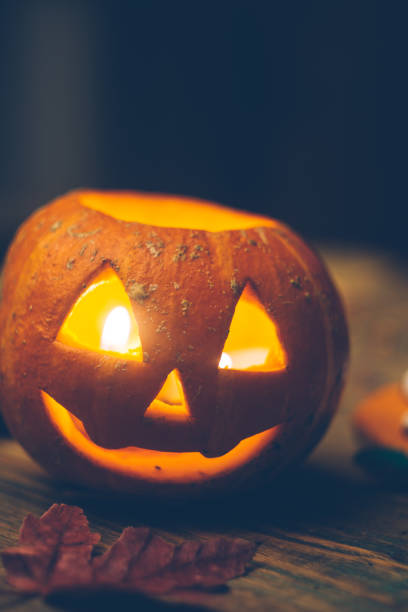 istock Halloween background with pumpkin on the wooden table. 1054927922
