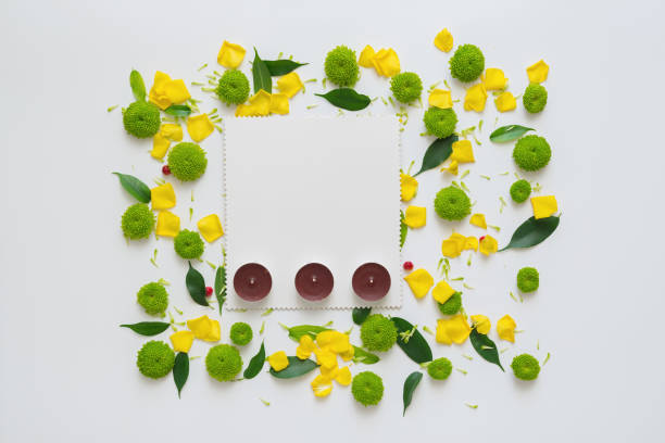 istock Candles and sheet of paper with pattern from petals. 1054928136