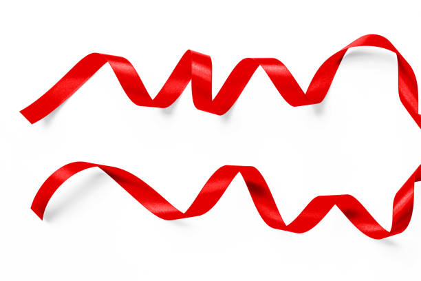 istock Red satin ribbon curly bow color isolated on white background with clipping path for Christmas holiday greeting card design decoration element 1054929748