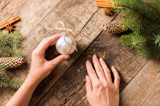 istock Young woman decorating the Christmas tree, cone 1054929954