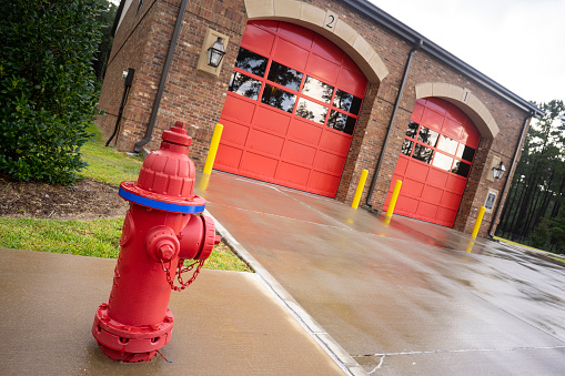 A fire hydrant stands outside the two bay garage that serve as the fire department truck protection