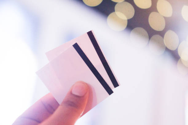 istock Hand holding two cinema tickets (movie cinema concept concept) 1054932296