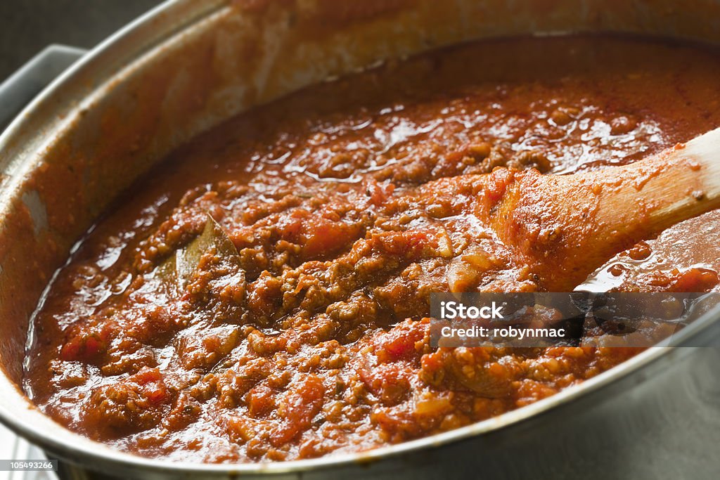 Large pot of Bolognese sauce cooking Rich Bolognese sauce cooking in a saucepan, with wooden spoon, ready for your pasta dish.  More beef images: Bolognese Sauce Stock Photo