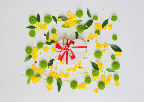 istock Gift in shape of heart with pattern from petals. 1054934258