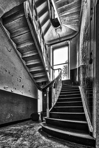 istock Abandoned stairwell in mansion iwth window view 1054940648