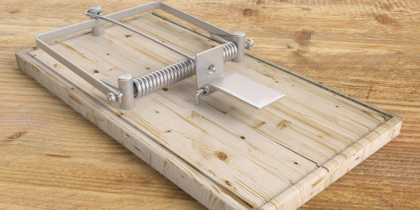 istock Mouse trap empty on wooden floor. 3d illustration 1054945420