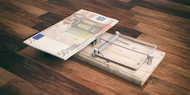 istock Euros banknotes on a mouse trap isolated on wooden background. 3d illustration 1054945482