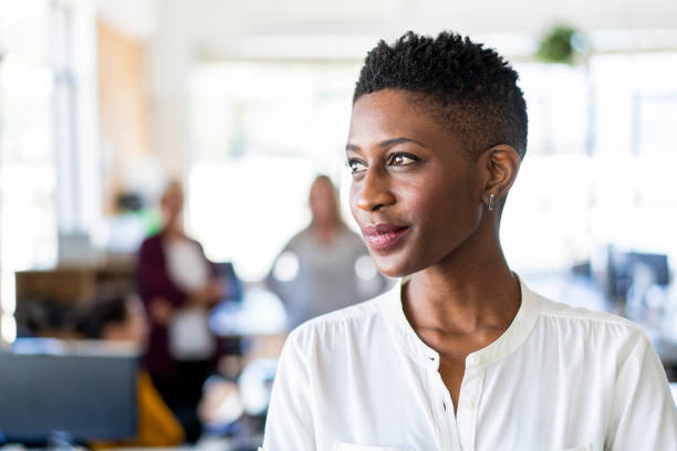 istock Businesswoman day dreaming at creative workplace 1054945488