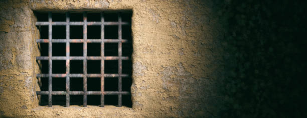 istock Prison, jail window with rusty bars on old wall background. Banner, copy space. 3d illustration 1054945664