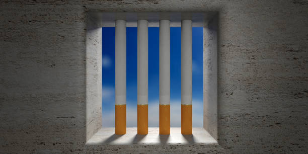istock Quit smoking. Cigarettes prison bars, blue sky outside. 3d illustration 1054948174