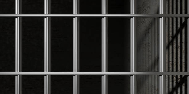 istock Prison, jail bars on black wall background. 3d illustration 1054948192