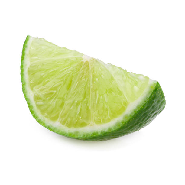 istock Half with slice of fresh green lime isolated on white background 1054949116