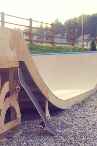 istock Skateboard standing on half pipe ramp at skate park. 1054952086