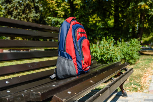 istock Tourist backpack on a bench in city park 1054952862