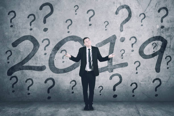 istock Confused male manager with number 2019 1054955762