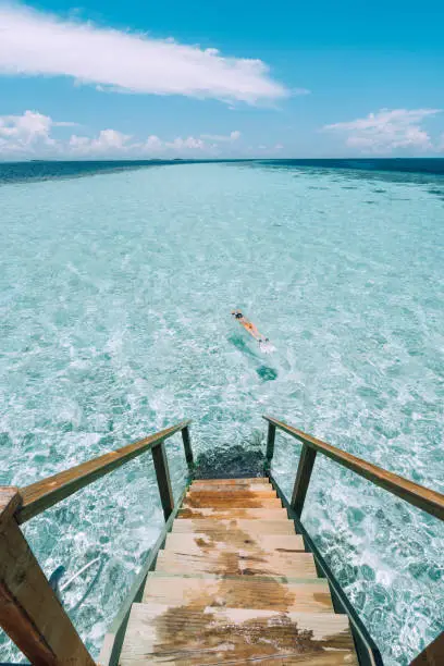 Photo of Young adult woman snorkeling in a turquoise clear sea