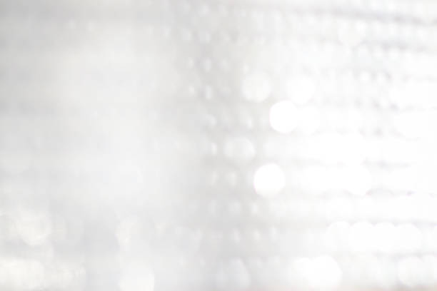istock abstract background of white bokeh lights. 1054956226