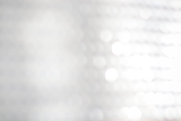 istock abstract background of white bokeh lights. 1054956230