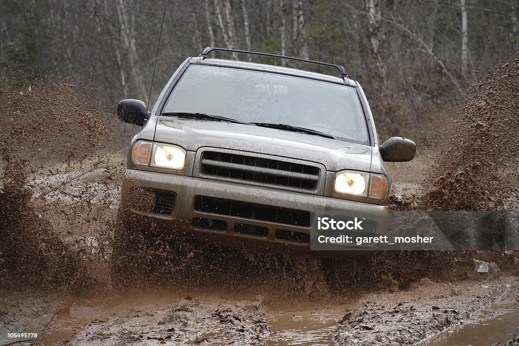 4x4 SUV blasting through the mud offroad  Mud Stock Photo