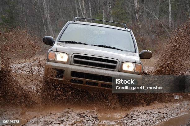 4x4 Suv Blasting Through The Mud Offroad Stock Photo - Download Image Now - Mud, Off-Road Vehicle, Sports Utility Vehicle