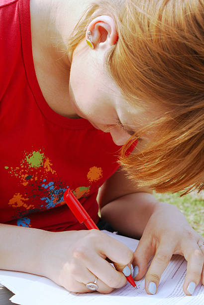 girl's writing on her knees stock photo