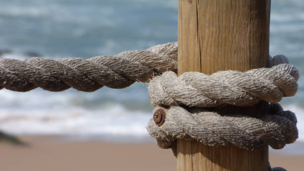 istock Rough Thick Rope Railing Beach Tropical Environment Wooden Post Ocean 1054962146