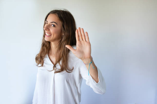 istock Cheerful grimacing young woman making stop gesture 1054963134