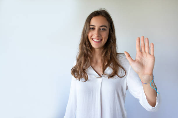 istock Happy attractive young woman giving five to camera 1054963178