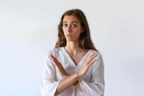 istock Beautiful serious freelancer showing forbidden symbol 1054965930