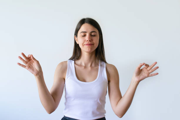 istock Calm brunette woman meditating with hands in knowledge mudra 1054965942