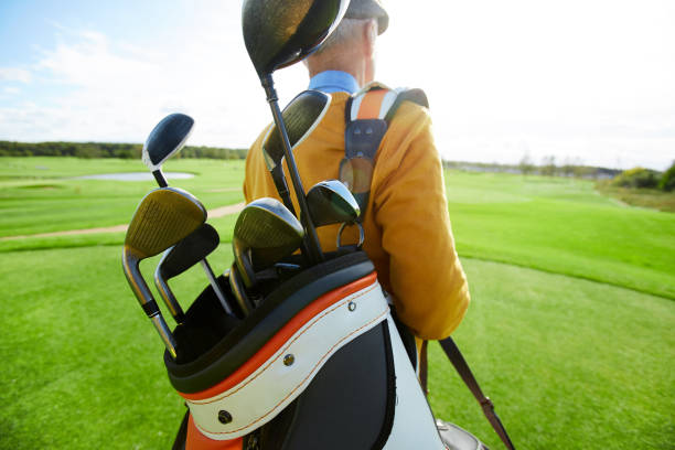 istock Carrying golf clubs 1054966206